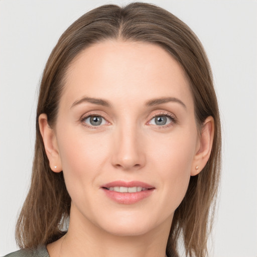 Joyful white young-adult female with long  brown hair and grey eyes