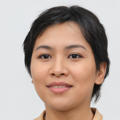Joyful latino young-adult female with medium  black hair and brown eyes