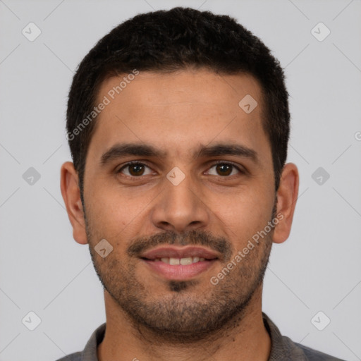 Joyful latino young-adult male with short  brown hair and brown eyes