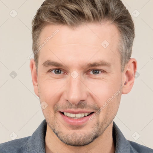 Joyful white adult male with short  brown hair and grey eyes