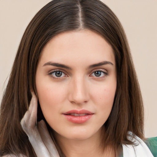 Neutral white young-adult female with long  brown hair and brown eyes