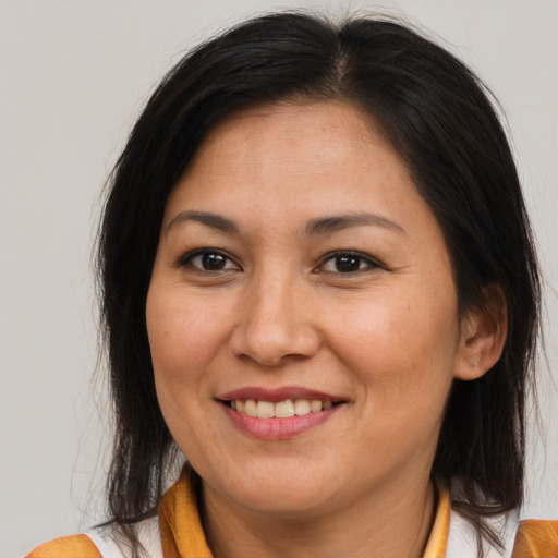 Joyful asian adult female with medium  brown hair and brown eyes