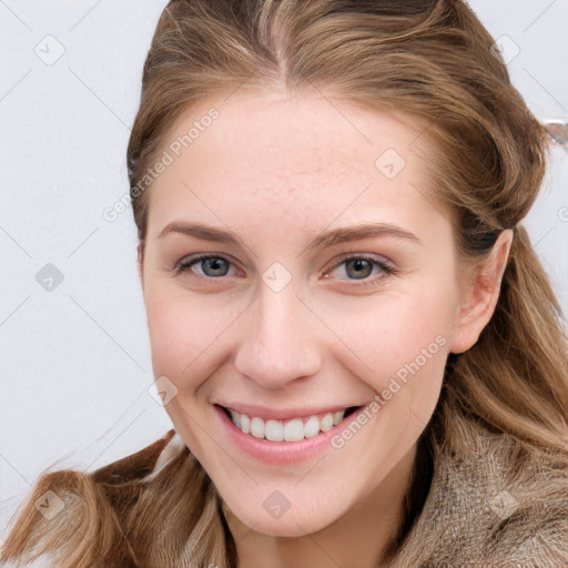 Joyful white young-adult female with long  brown hair and blue eyes