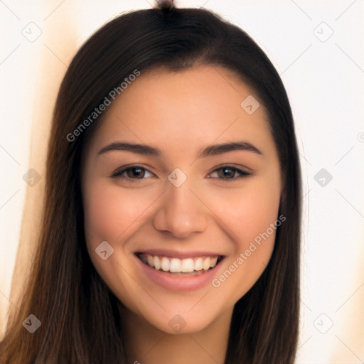 Joyful latino young-adult female with long  brown hair and brown eyes