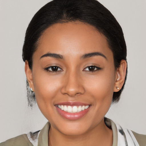 Joyful latino young-adult female with medium  black hair and brown eyes