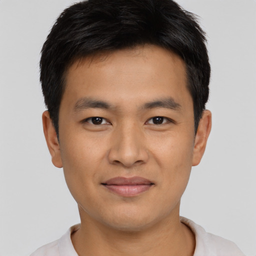 Joyful asian young-adult male with short  brown hair and brown eyes