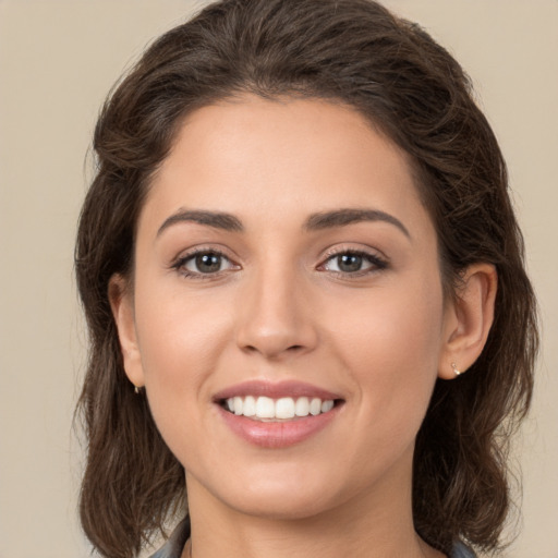 Joyful white young-adult female with medium  brown hair and brown eyes