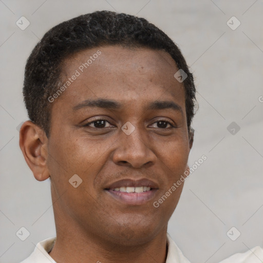 Joyful latino young-adult male with short  brown hair and brown eyes