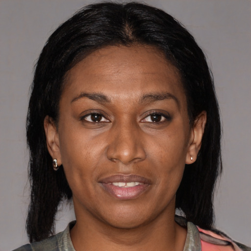 Joyful latino adult female with medium  brown hair and brown eyes