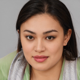 Joyful asian young-adult female with medium  brown hair and brown eyes