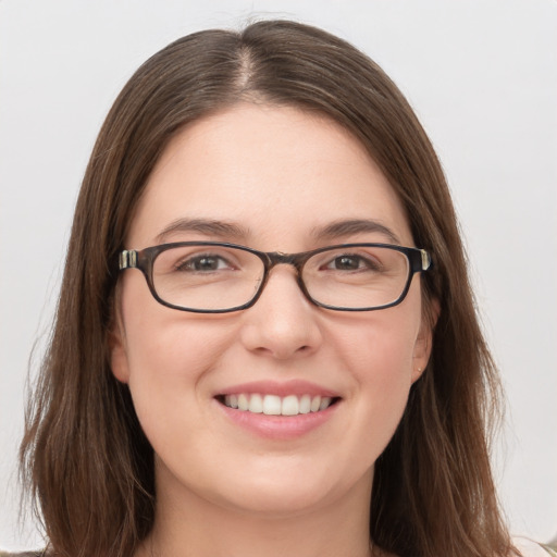 Joyful white young-adult female with medium  brown hair and grey eyes