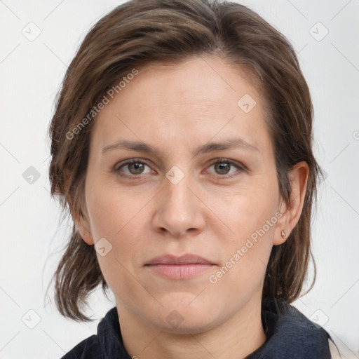 Joyful white adult female with medium  brown hair and grey eyes