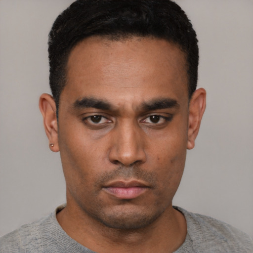 Neutral latino young-adult male with short  black hair and brown eyes