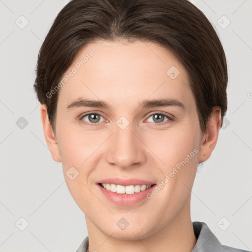 Joyful white young-adult female with short  brown hair and grey eyes