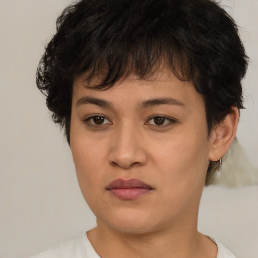 Joyful asian young-adult female with short  brown hair and brown eyes