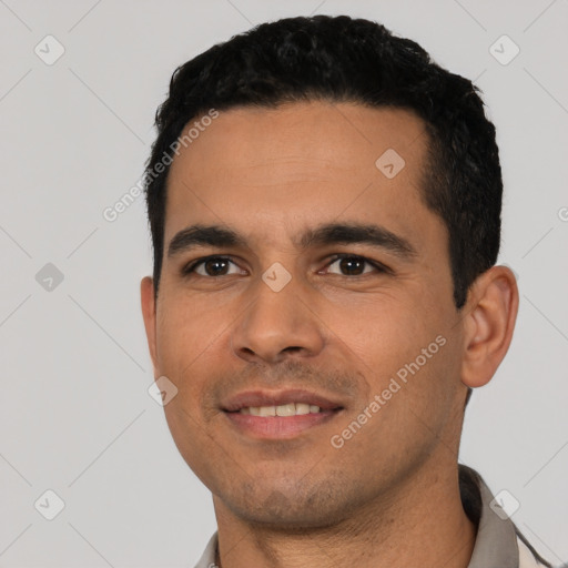 Joyful latino young-adult male with short  black hair and brown eyes