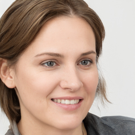 Joyful white young-adult female with medium  brown hair and blue eyes