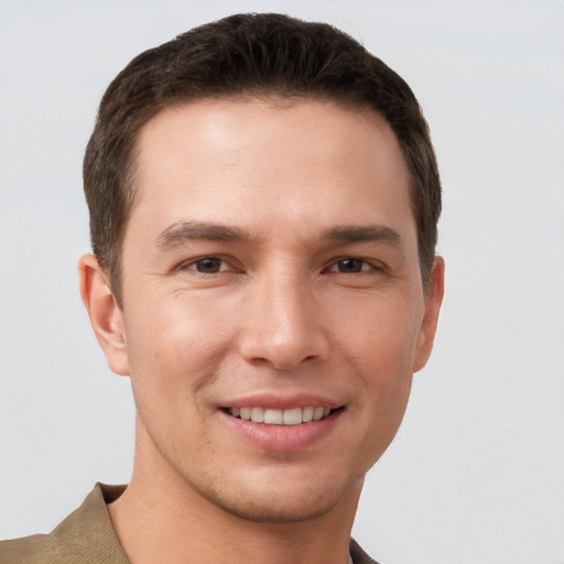 Joyful white young-adult male with short  brown hair and grey eyes