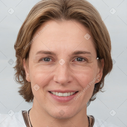 Joyful white adult female with medium  brown hair and grey eyes