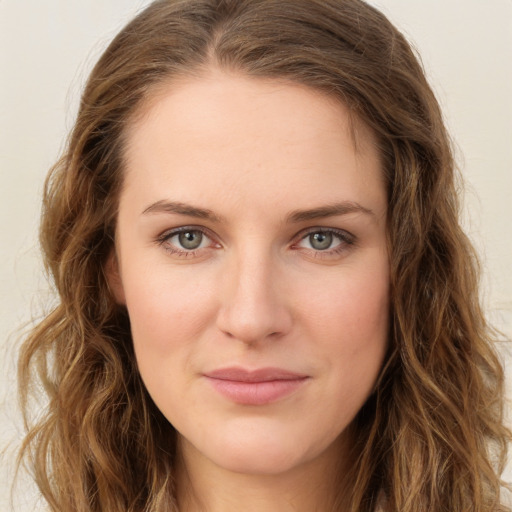 Joyful white young-adult female with long  brown hair and green eyes