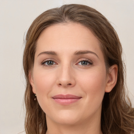 Joyful white young-adult female with long  brown hair and grey eyes