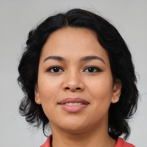 Joyful latino young-adult female with medium  black hair and brown eyes