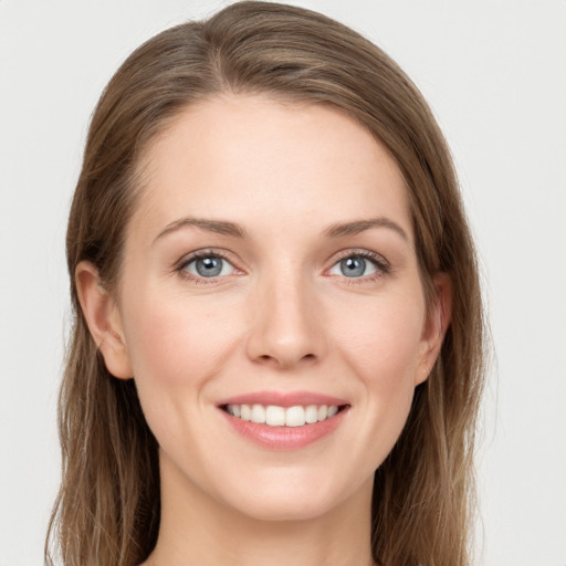 Joyful white young-adult female with long  brown hair and grey eyes