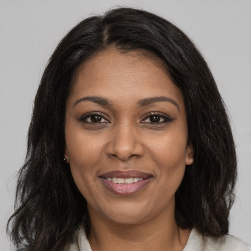 Joyful black young-adult female with medium  black hair and brown eyes