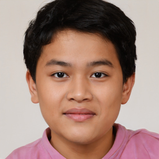 Joyful latino child male with short  black hair and brown eyes