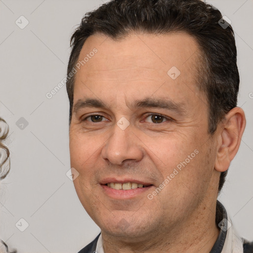 Joyful white adult male with short  brown hair and brown eyes