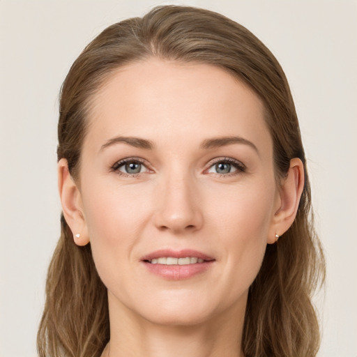 Joyful white young-adult female with long  brown hair and grey eyes