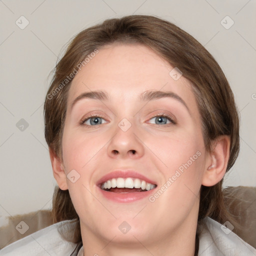 Joyful white young-adult female with medium  brown hair and blue eyes