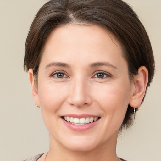 Joyful white young-adult female with short  brown hair and brown eyes