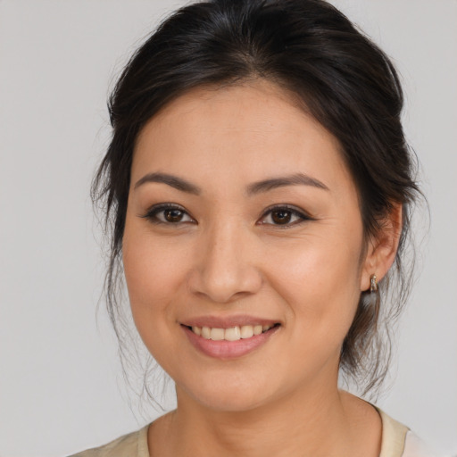 Joyful white young-adult female with medium  brown hair and brown eyes