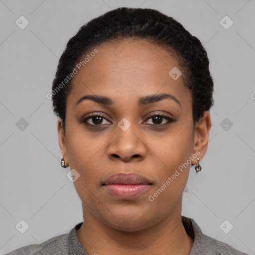 Joyful black young-adult female with short  black hair and brown eyes