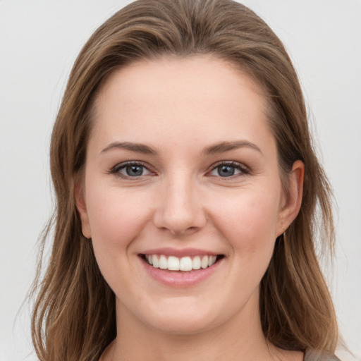 Joyful white young-adult female with medium  brown hair and grey eyes