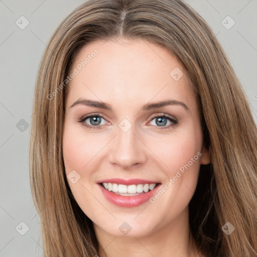 Joyful white young-adult female with long  brown hair and green eyes