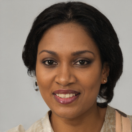 Joyful black young-adult female with medium  brown hair and brown eyes