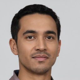 Neutral latino young-adult male with short  black hair and brown eyes