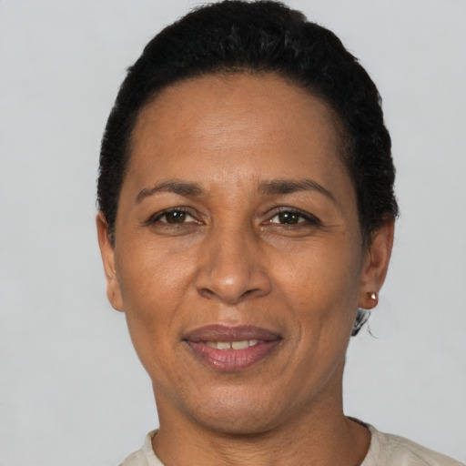 Joyful latino adult female with short  black hair and brown eyes