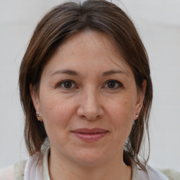 Joyful white adult female with medium  brown hair and brown eyes