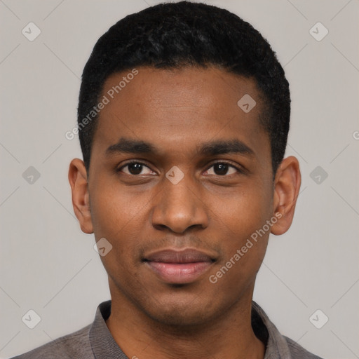 Joyful black young-adult male with short  black hair and brown eyes