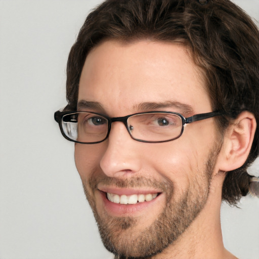 Joyful white adult male with short  brown hair and green eyes