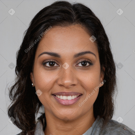 Joyful black young-adult female with long  brown hair and brown eyes