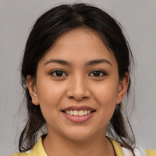 Joyful latino young-adult female with medium  brown hair and brown eyes