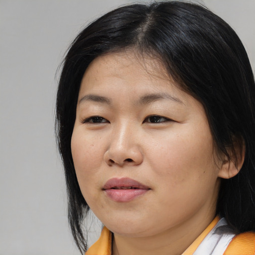 Joyful asian young-adult female with medium  black hair and brown eyes