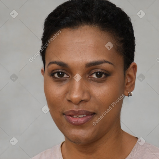 Joyful black young-adult female with short  black hair and brown eyes