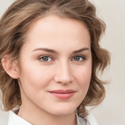 Joyful white young-adult female with medium  brown hair and blue eyes