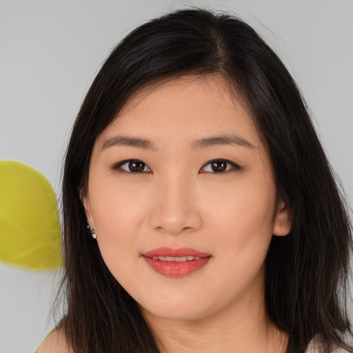 Joyful asian young-adult female with long  brown hair and brown eyes