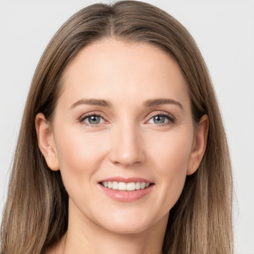 Joyful white young-adult female with long  brown hair and grey eyes